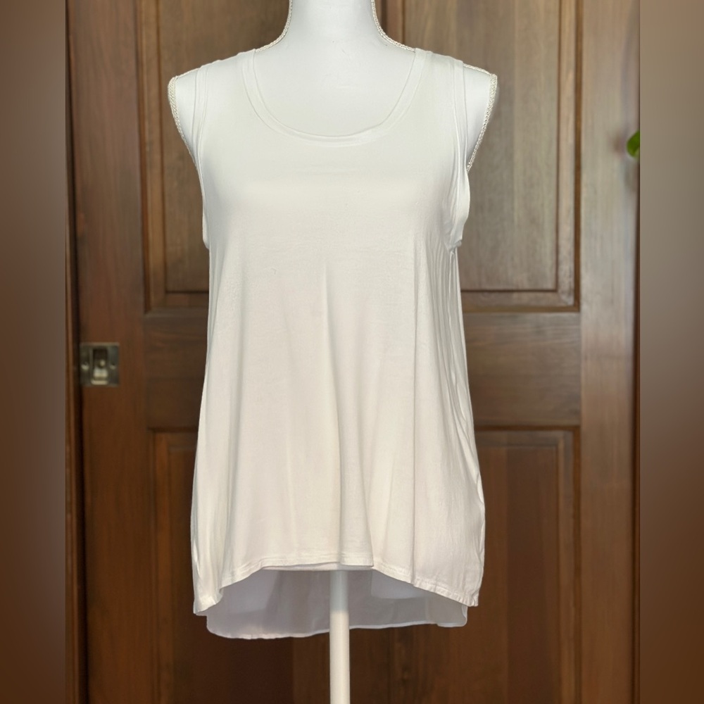 Banana Republic sleeveless white tank style top, longer and sheer in back.